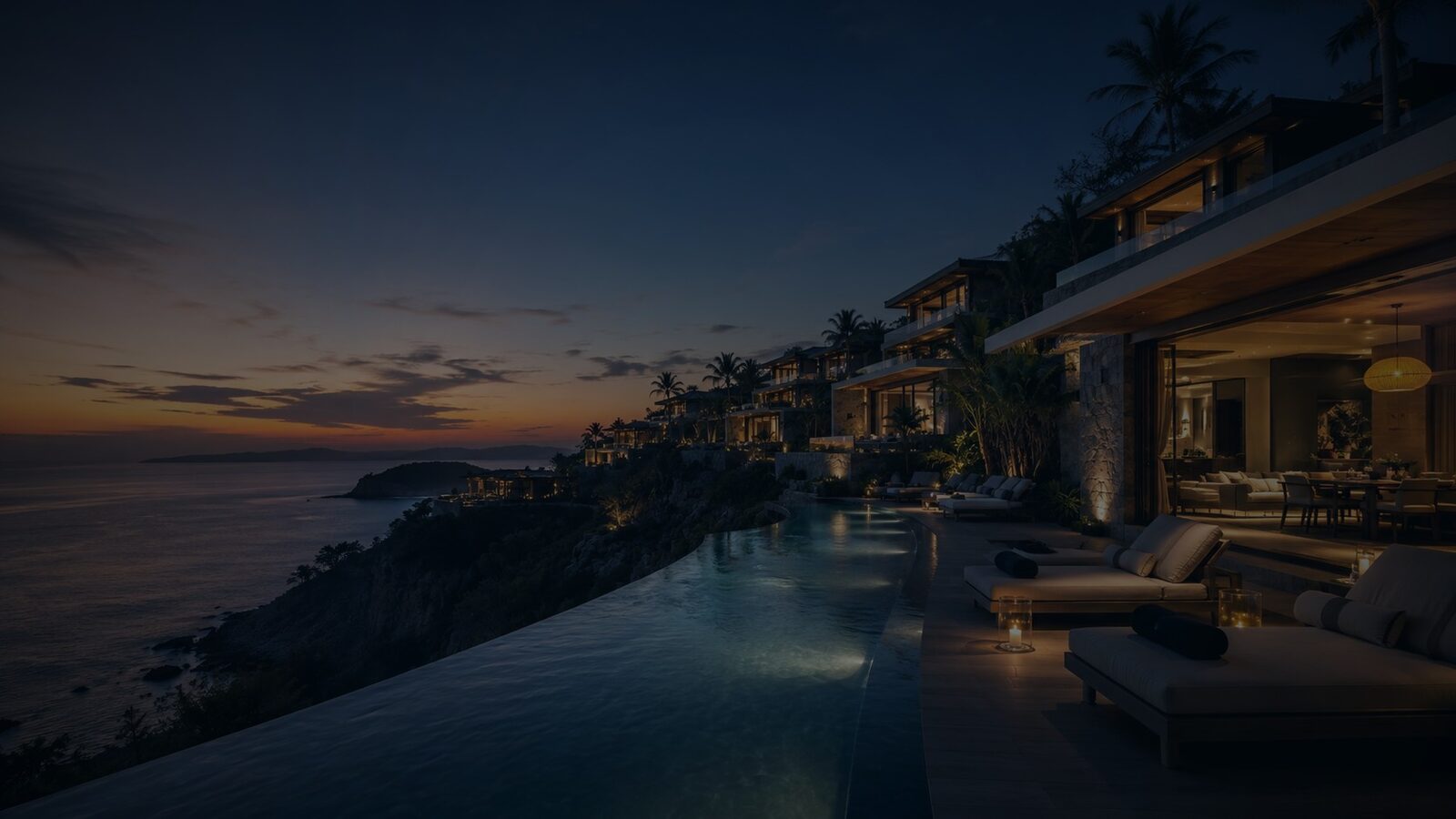Cliffside luxury villas overlooking the sea at twilight