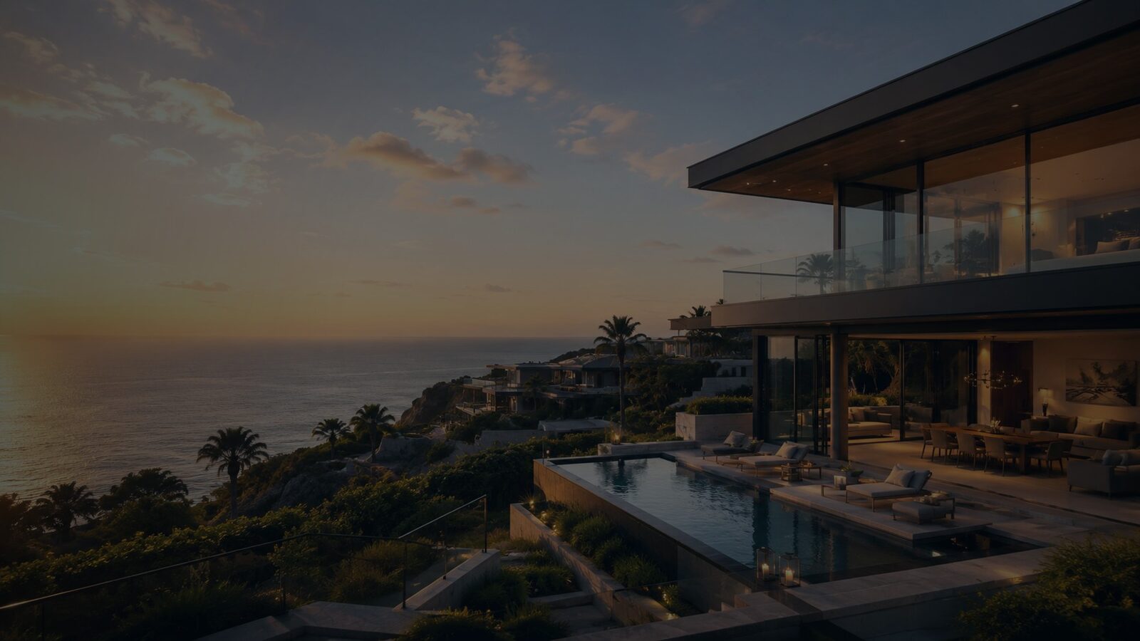 Contemporary cliffside private villa with infinity pool at dusk